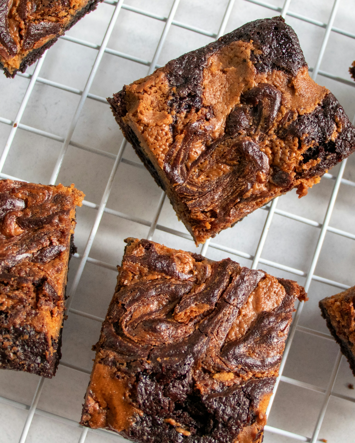 Swirled brownies cooling on a wire rack