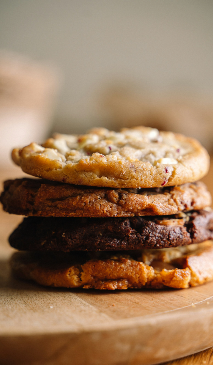 Stack of cookies and brownies on a wooden board